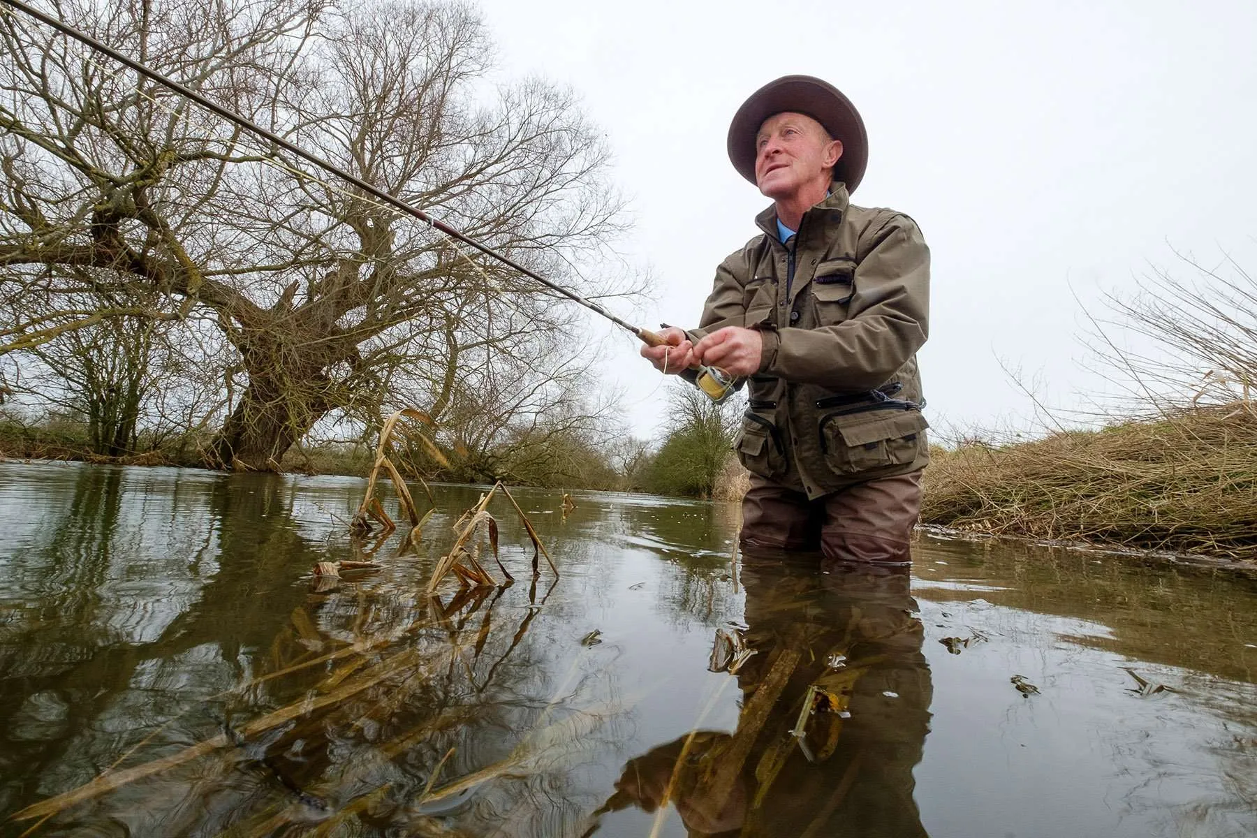 Fly Fisherman David Wood in the river at Cricklade, Cotswolds, UK.